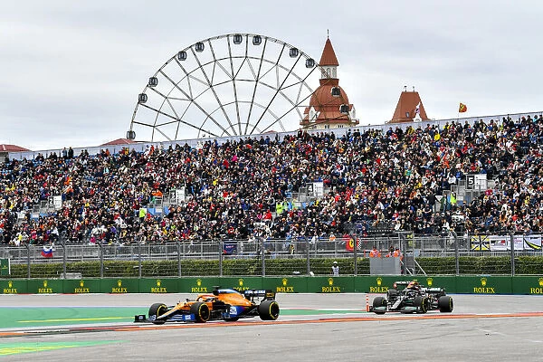 Action. Daniel Ricciardo, McLaren MCL35M, leads Sir Lewis Hamilton, Mercedes W12
